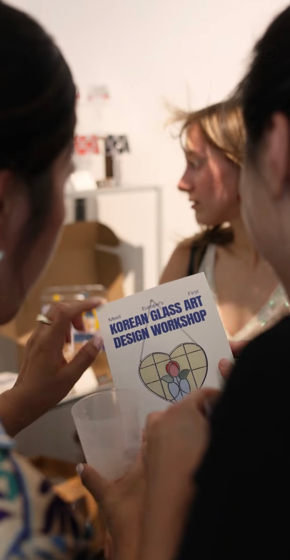 >Students at a Korean glass art workshop
